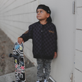 Child wearing a checkered waterproof letterman jacket