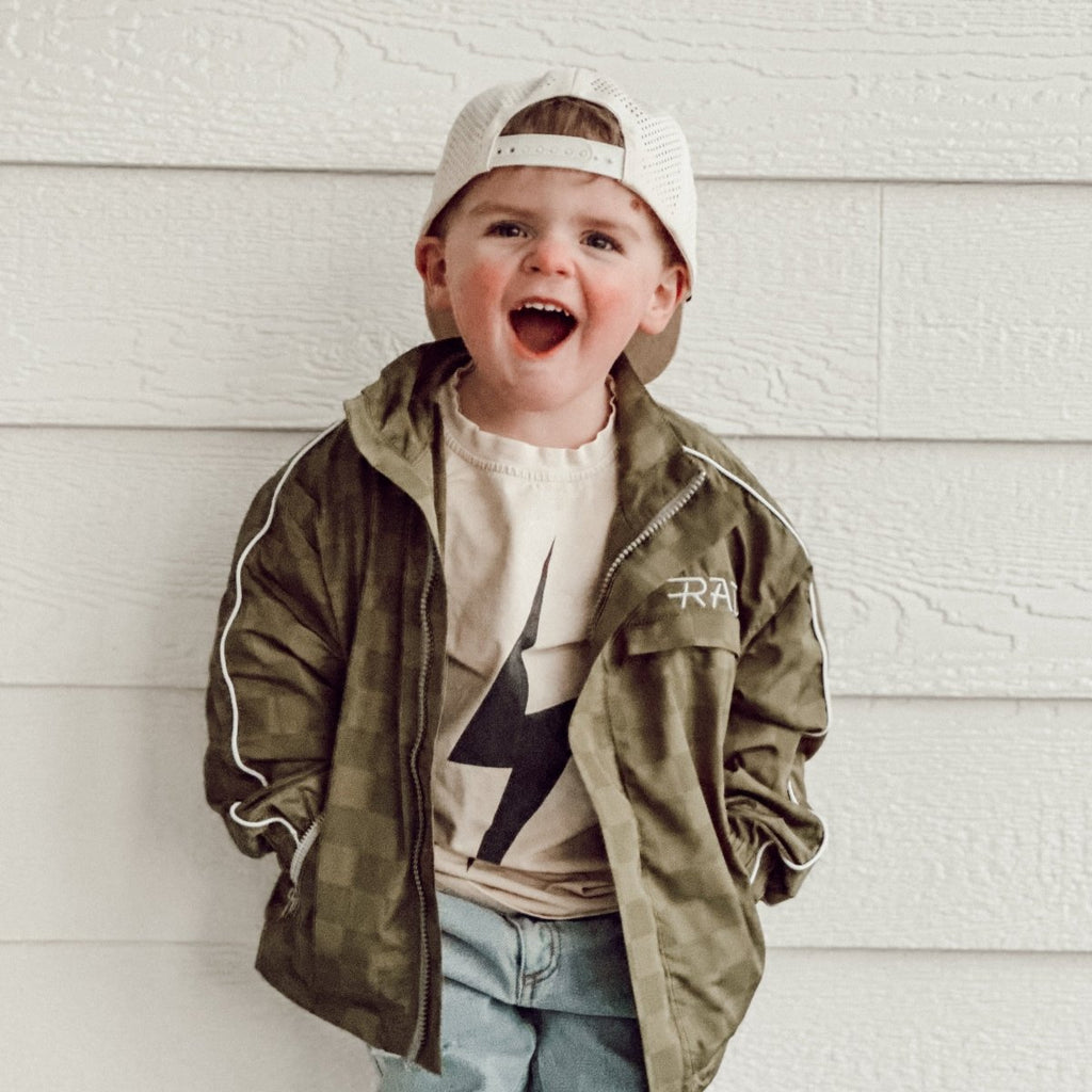 Child wearing the Storm Rider waterproof jacket in army green
